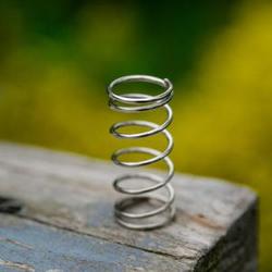 coiled_spring_atop_wooden_table_-_thumbnail Thumb
